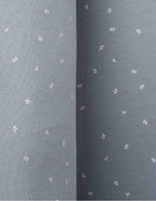 Detalle del cojín protector Hojas Blancas con estampado floral en algodón orgánico certificado