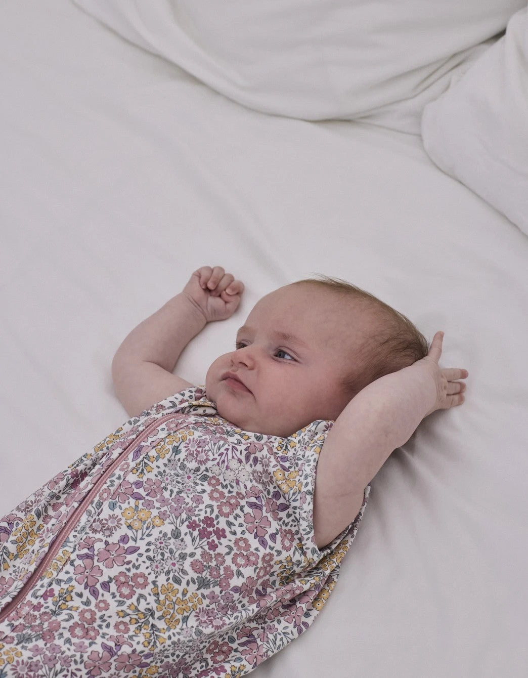 Saco de dormir Liberty Rosa TOG 0.5 con estampado floral en uso.